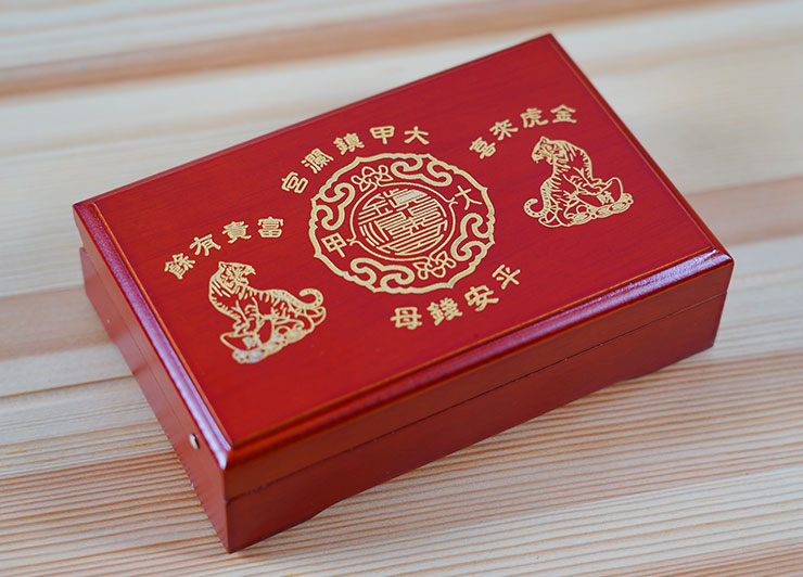 虎年木盒錢母，盒身也是喜氣的大紅色搭配金字，有喜氣洋涂的「金虎來喜」、「富貴有餘」的吉祥話