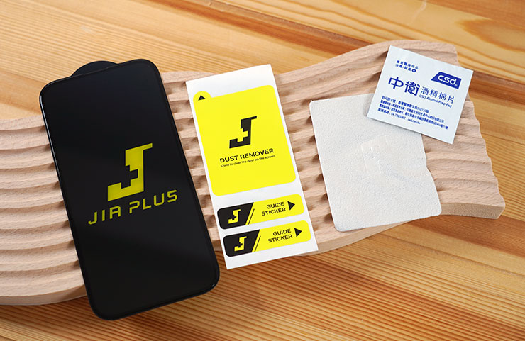 盒內物品一覽，包括帶黑色底板的保護貼本體，除塵貼、擦拭布與酒精棉片。
